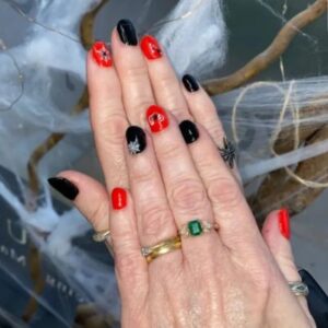 Halloween inspired autumn nails with dark red and pumpkin design at Altrincham salon